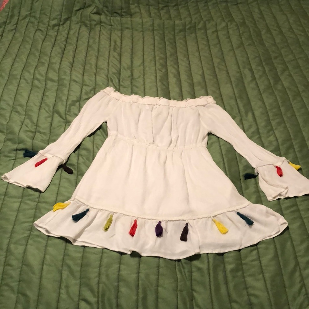 White shirt dress with colorful tassels.